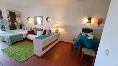 a living room with a bed and a couch at ALBUFEIRA TRADICIONAL BEACH APARTMENT in Albufeira