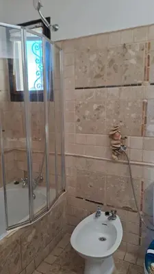 a bathroom with a shower and a toilet and a sink at ALBUFEIRA TRADICIONAL BEACH APARTMENT in Albufeira