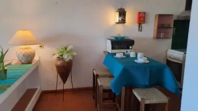 a kitchen with a table with a blue table cloth at ALBUFEIRA TRADICIONAL BEACH APARTMENT in Albufeira