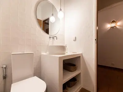 a bathroom with a toilet and a sink and a mirror at Akisol Albufeira Euphoria in Albufeira