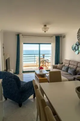 a living room with a view of the ocean at Ocean Blue II in Quarteira