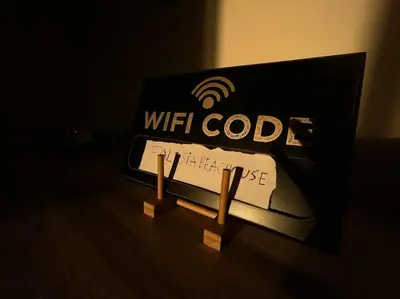 a sign for a wifi code on a table at Falésia Beach Apartment in Albufeira