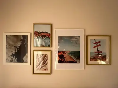 a group of four pictures hanging on a wall at Falésia Beach Apartment in Albufeira