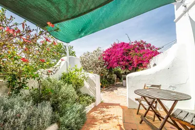a picnic table in a garden with flowers at BeGuest Casa Romãzeira Typical Vila in Goncinha