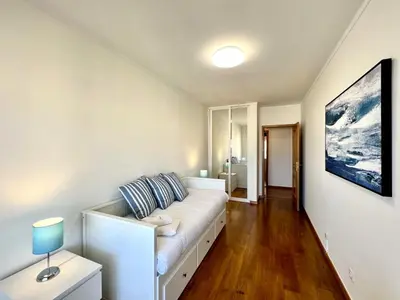 a living room with a white couch in a room at Faro Rising by Homing in Faro
