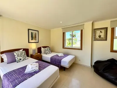 a hotel room with two beds and a window at Vilamoura Amazing Golf Villa With Pool by Homing in Vilamoura
