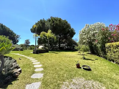 a garden with a path in the grass at Vilamoura Amazing Golf Villa With Pool by Homing in Vilamoura