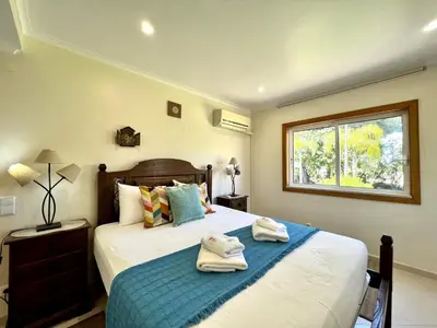 a bedroom with a bed with towels on it at Vilamoura Amazing Golf Villa With Pool by Homing in Vilamoura