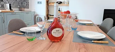 a kitchen with a table and a dining room at Faro Comfy Ensuite Guest House in Faro