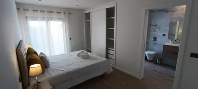 a white bedroom with a bed and a bathroom at Faro Comfy Ensuite Guest House in Faro