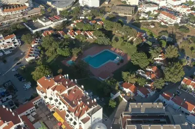 an aerial view of a suburb with a pool at Cozy Albufeira Charm in Albufeira