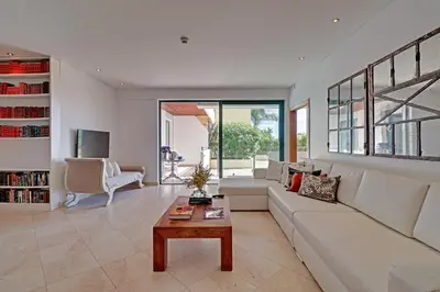 a living room with a white couch and a table at News Apartment in Vilamoura