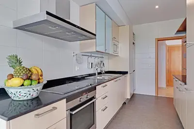 a kitchen with a bowl of fruit on a counter at News Apartment in Vilamoura
