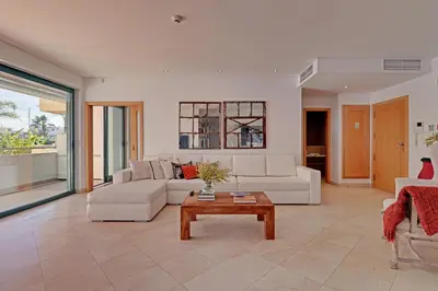 a living room with a couch and a table at News Apartment in Vilamoura