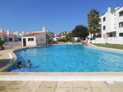 two children swimming in a large swimming pool at Apt-236 in Albufeira