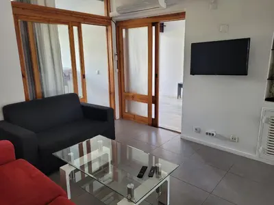a living room with a couch and a glass coffee table at Apt-236 in Albufeira