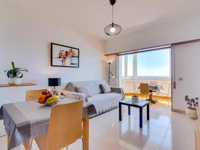 a living room with a couch and a table at AL - Apartamento Portas do Mar in Quarteira