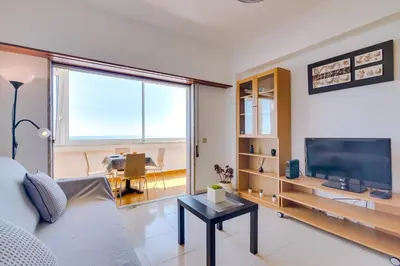 a living room with a couch and a tv at AL - Apartamento Portas do Mar in Quarteira