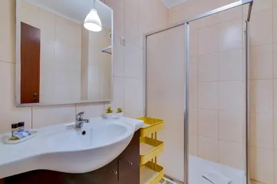 a bathroom with a sink and a shower at AL - Apartamento Portas do Mar in Quarteira