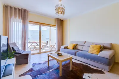 a living room with a couch and a table at AL - Apartamento Falésia Flat in Vilamoura