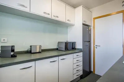 a bathroom with a sink and a toilet and a mirror at Swiss Green Appartement Cosy et Spacieux in Quarteira