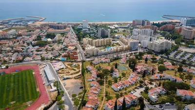 an aerial view of a city with buildings and the ocean at Vilamoura Coastal Retreat by LovelyStay in Vilamoura