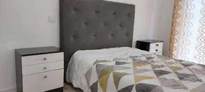 a bedroom with a bed with a black and white comforter at Monica in Quarteira