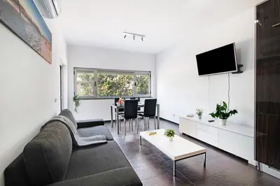 a living room with a couch and a table at Apartamento Oceano in Albufeira
