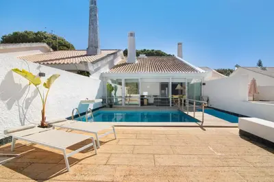 a villa with a swimming pool and a house at Vilamoura com Piscina e Wifi in Vilamoura