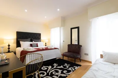a bedroom with a bed and a desk and a chair at Sunny, The House - AL in Faro