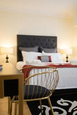 a bedroom with a bed with a chair and a table at Sunny, The House - AL in Faro