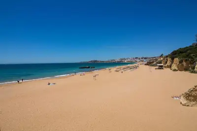 a beach with a lot of people and the ocean at Barracuda A14 in Albufeira