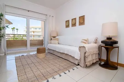a living room with a couch and a large window at Barracuda A14 in Albufeira