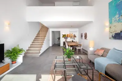 a living room with a couch and a table at Casa Relax à Olhos Albufeira in Albufeira