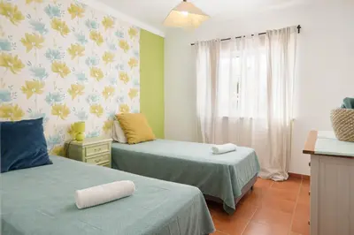 a bedroom with two beds and a window at JUDY - Albufeira in Albufeira