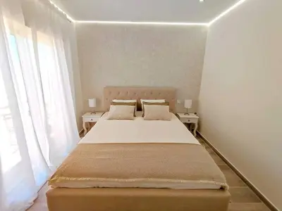 a bedroom with a large bed with two tables at Lovely Terrace Apart. Downtown in Faro