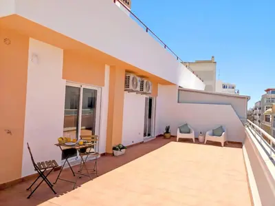 a balcony of a house with a table and chairs at Lovely Terrace Apart. Downtown in Faro