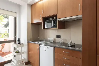 a kitchen with a sink and a microwave at Alvaflor 102 - Vilamoura by HD Properties in Vilamoura