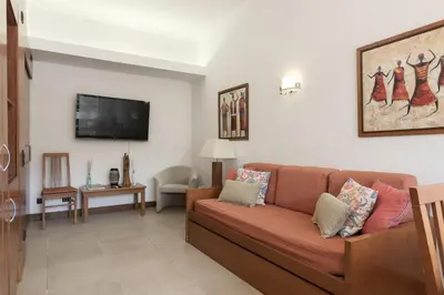 a living room with a couch and a tv at Alvaflor 102 - Vilamoura by HD Properties in Vilamoura
