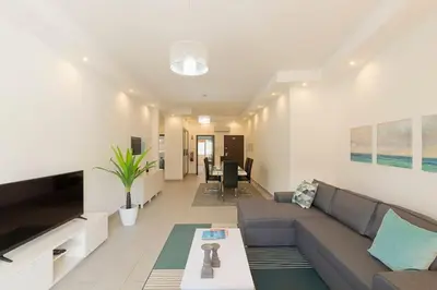 a living room with a couch and a table at Albufeira Old Town Center - VERASOL 1 in Albufeira