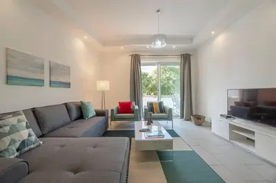 a living room with a couch and a tv at Albufeira Old Town Center - VERASOL 1 in Albufeira