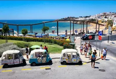 a group of people standing in a parking lot with small cars at Albufeira, OLD TOWN - VERASOL N in Albufeira