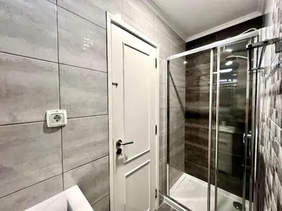 a bathroom with a shower and a glass door at Quarteira Ocean Breeze 1 With Pool by Homing in Quarteira