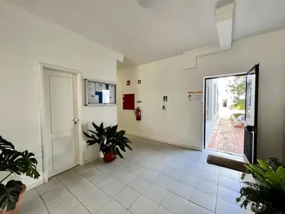 an empty hallway with a door and a plant at Quarteira Ocean Breeze 1 With Pool by Homing in Quarteira