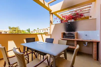 a patio with a table and chairs on a balcony at Casa Colina 2 in Albufeira