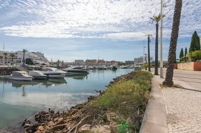 a body of water with boats in a harbor at Vilamoura Marina Lake in Vilamoura