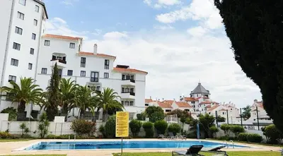 a view of a building and a swimming pool at Marina Holiday House in Quarteira