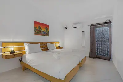 a bedroom with two beds and a window at Pool side Villa Zara in Albufeira