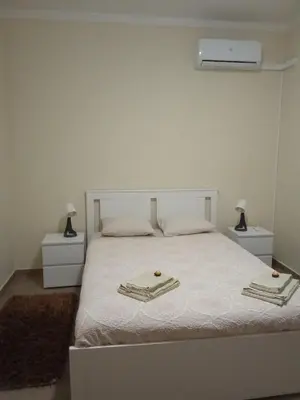 a bedroom with a white bed with two towels on it at Apartamento T3 in Faro
