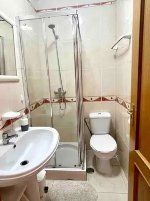 a bathroom with a shower and a toilet and a sink at Vilamoura-Praia da Falésia T2 in Quarteira